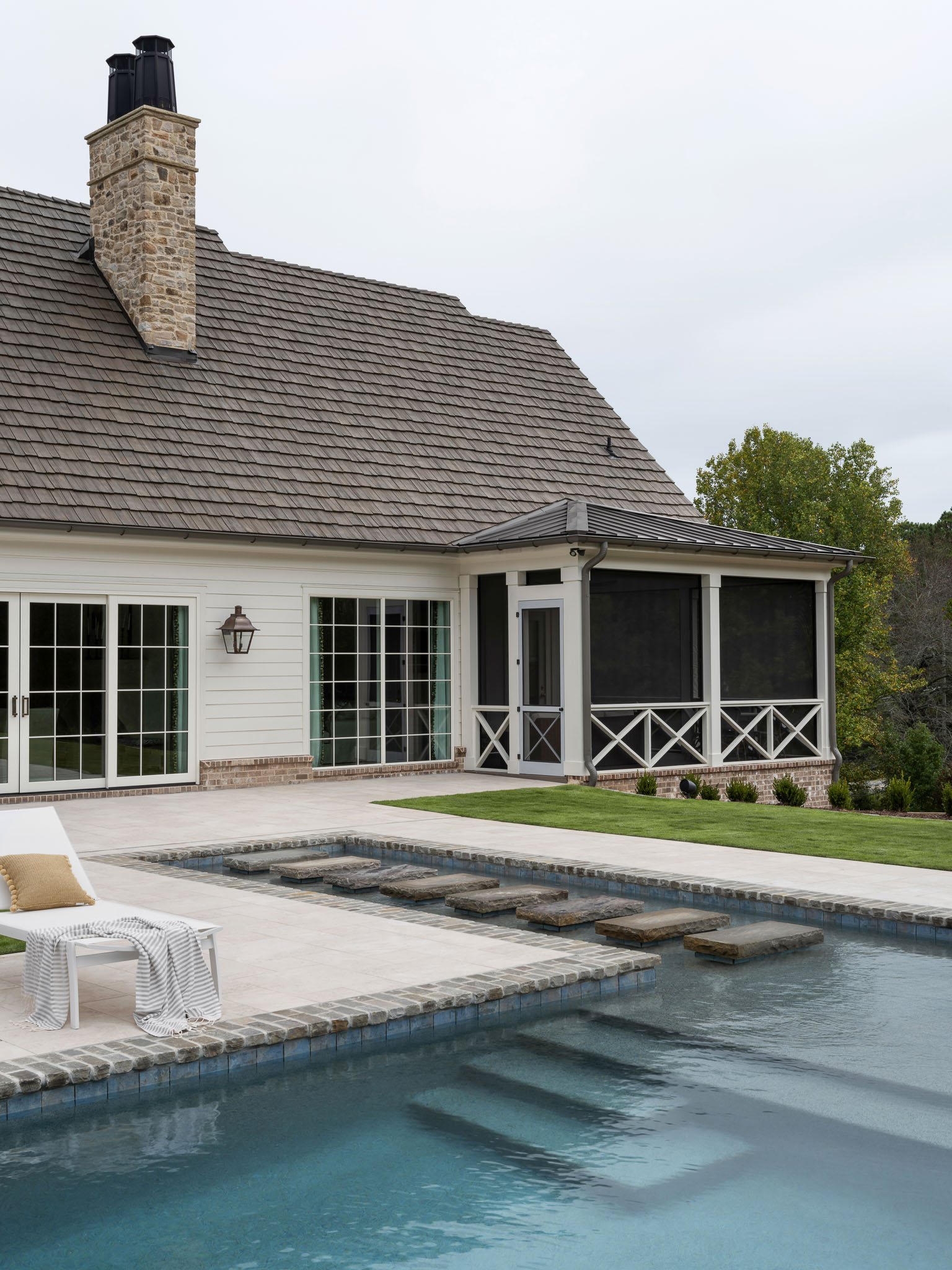 Backyard pool in backyard of custom home build by Ecraft