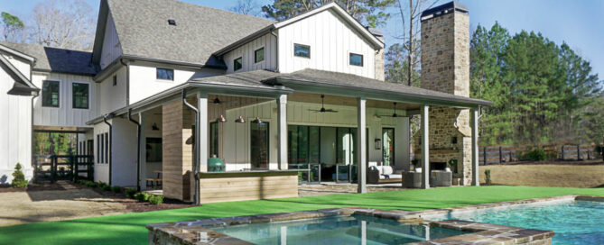 Back exterior of a custom home built by Ecraft, featuring covered back patio and pool/spa